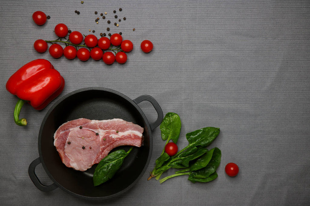 piece of appetizer fresh meat for steak with spaces, greens and vegetables isolated on the table - 写真・画像