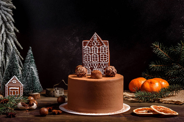 Christmas holiday table with delicious truffle cake and beautiful gingerbreads - Photo, Image