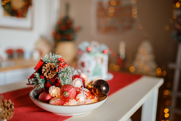 Beautiful holiday decorated kitchen with Christmas tree and bright lights , holiday glasses on the main plan, blur background - Fotoğraf, Görsel