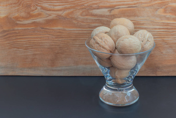 walnuts in a glass vase - Фото, зображення