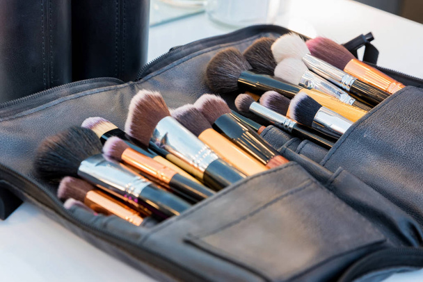 Set of makeup brushes lying in dark case - Photo, Image