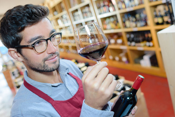 sommelier looking at a glass of wine - Foto, imagen