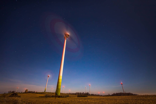 Wind turbine spinning fast at night sky in Lithuania, Europe - Valokuva, kuva