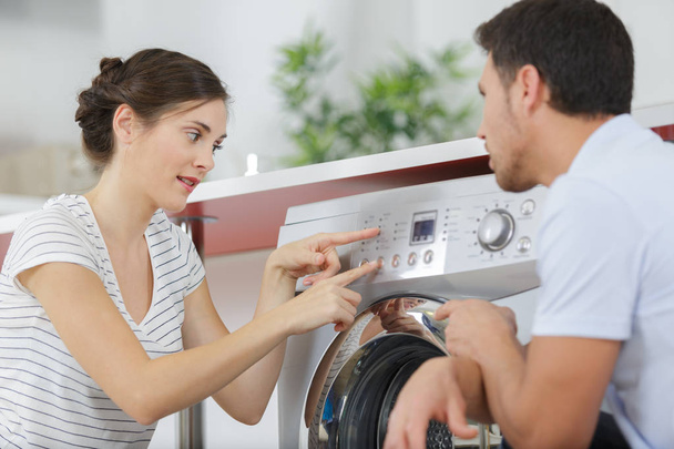 couple near washing machine at home - Φωτογραφία, εικόνα