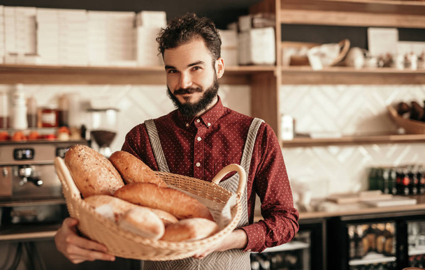 Friendly baker with fresh bread - Foto, imagen