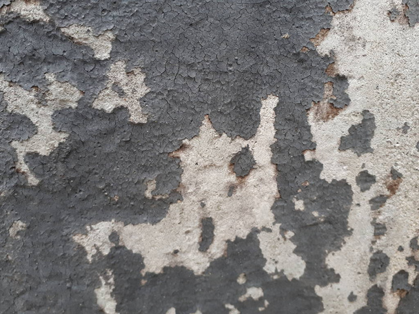  close-up of a decorative wall made of concrete, with a characteristic rough porous texture, abstract dark and light stains - Photo, Image