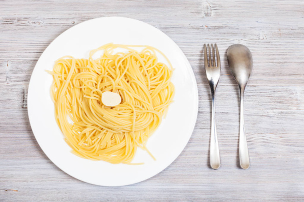 pasta with butter on plate and fork with spoon - Fotoğraf, Görsel