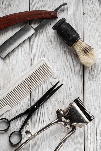 vintage barber tools dangerous razor hairdressing scissors old manual clipper comb shaving brush. vertical - Photo, Image