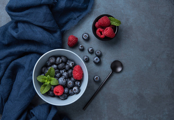 Čerstvé a sladké borůvky a maliny v misce s klasickou modrou - Fotografie, Obrázek