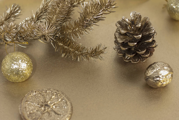 Vánoční nebo novoroční kompozice. Vánoční strom větev s hračkou, borovice kužel a oranžový plátek ve zlaté barvě. Koncept svátků a oslav pro blahopřání nebo pozvání. Kopírovat prostor - Fotografie, Obrázek