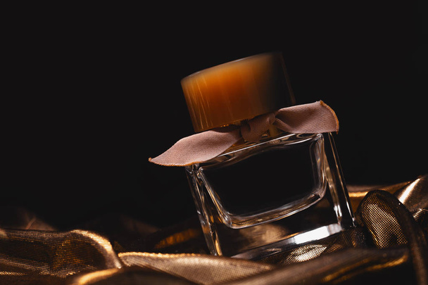 Bottle of perfume on dark background  - Фото, изображение