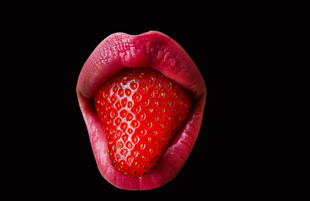 Lips with strawberries. Sexy sign on a black background. Cocktail bar. Hot party. Tasty berry flavor. Young woman holds a tasty snack in her mouth. Tasteful lubricant. - Photo, Image