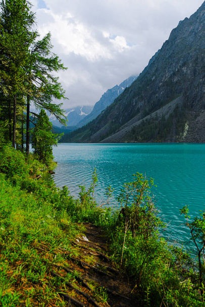 Turquoise lake among rocks. Mountain pond for hiking - Фото, зображення