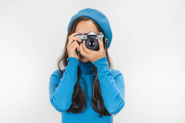 Woman in beret photographing on retro camera isolated over white background - Foto, imagen