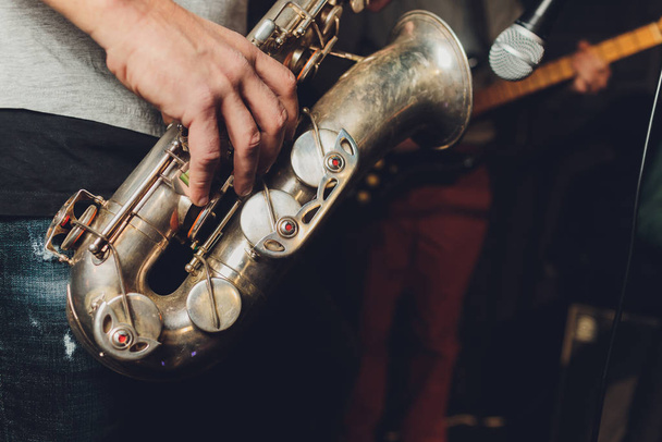 Saxophone player jazz musician. Saxophonist with baritone sax player. - Фото, изображение