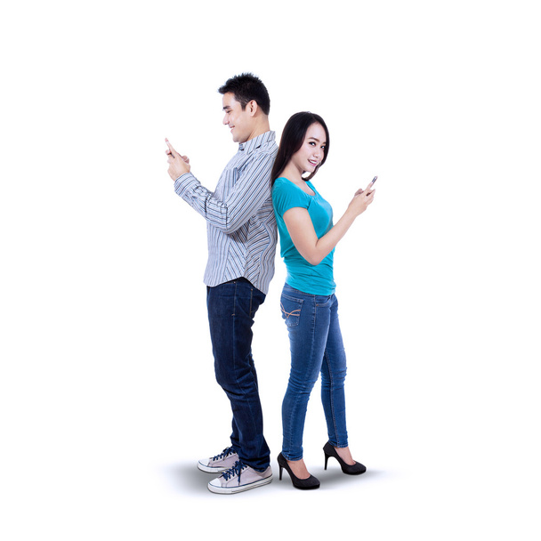Happy couple texting with mobile phone - Fotó, kép