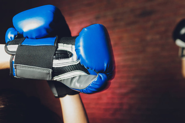 Female boxer with gloves up, close-up female hand. - Foto, Imagem