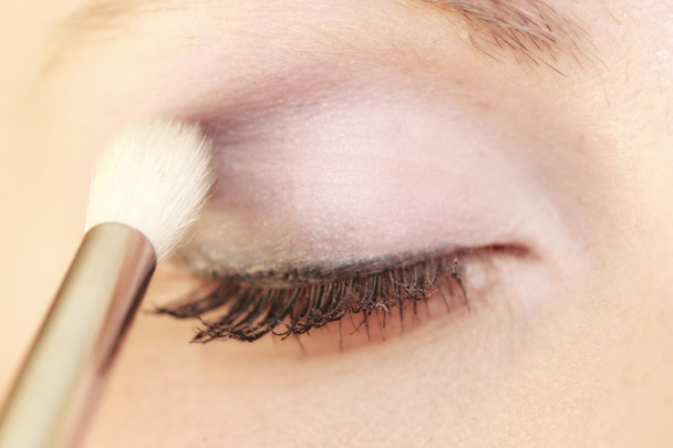 Part of face female eye makeup applying with brush - Foto, imagen