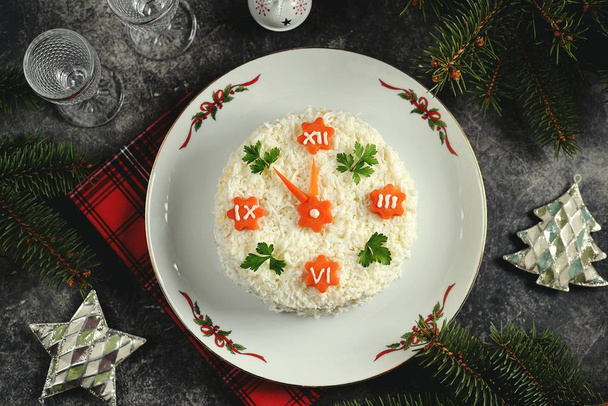 New Year's holiday salad "Clock". Traditional russian salad. Top view.  - Photo, Image