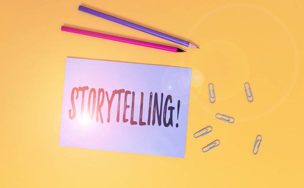 Conceptual hand writing showing Storytelling. Business photo text activity writing stories for publishing them to public Blank paper sheet message reminder pencils clip colored background. - Photo, Image