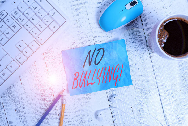 Handwriting text writing No Bullying. Concept meaning stop aggressive behavior among children power imbalance technological devices colored reminder paper office supplies keyboard mouse. - 写真・画像