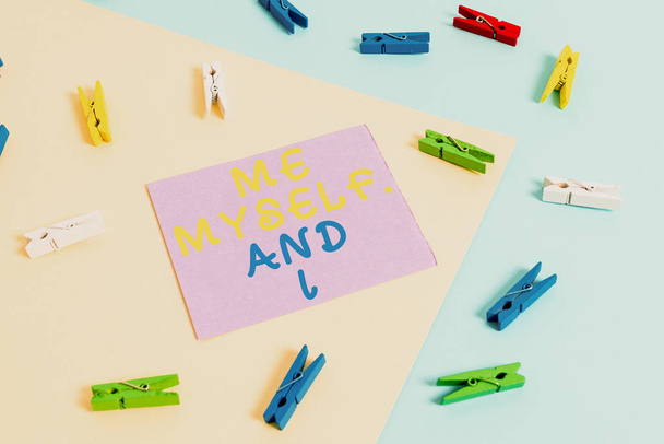 Conceptual hand writing showing Me Myself And I. Business photo showcasing used by speaker to refer to herself as the object of a verb Colored clothespin paper reminder with yellowblue background. - Photo, Image
