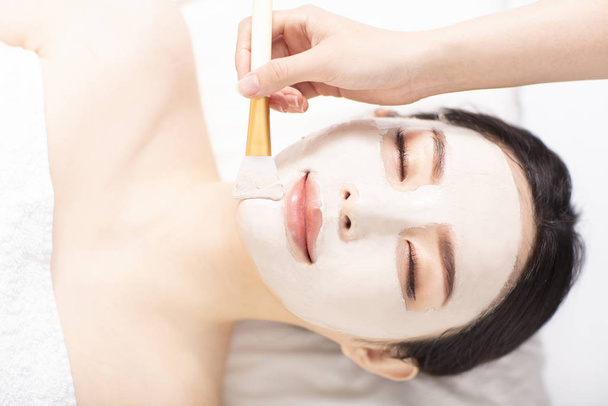 young Woman with mask on face in spa beauty salon - Foto, imagen