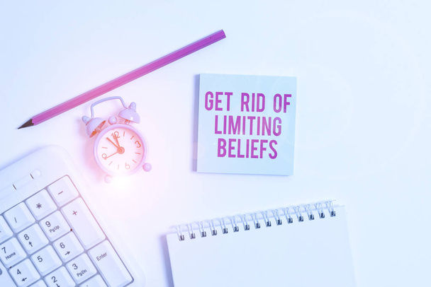 Handwriting text writing Get Rid Of Limiting Beliefs. Concept meaning remove negative beliefs and think positively White pc keyboard with empty note paper and pencil above white background. - Photo, Image