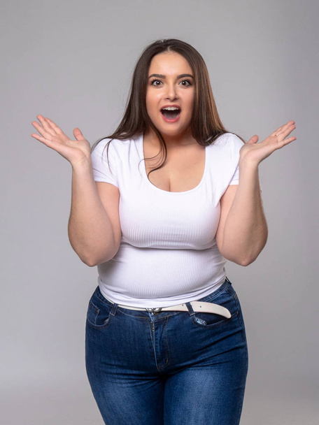 Shocked Plus Size Model with long hair posing in studio - Photo, Image