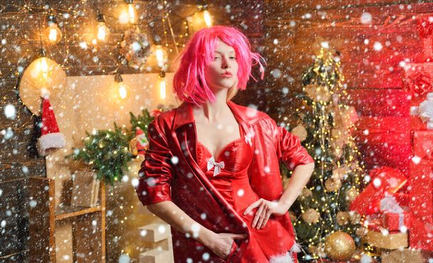 Sexy fashion girl celebrate new year and merry christmas. Red outfit christmas. Girl in snow. Christmas celebration. Girl pink wig leather jacket at home near christmas tree. Love peace and joy for - Photo, Image