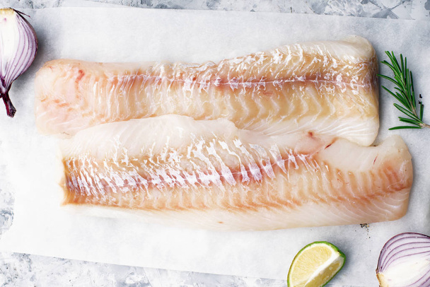 Fillet of white sea organic cod before cooking with minimal healthy food ingredients. Pure protein. Top view - Foto, Imagen