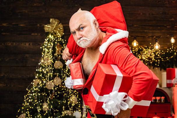 Thief Santa with bag on christmas background. Thief stole new years presents. Christmas safety from burglars and home security. - Foto, imagen