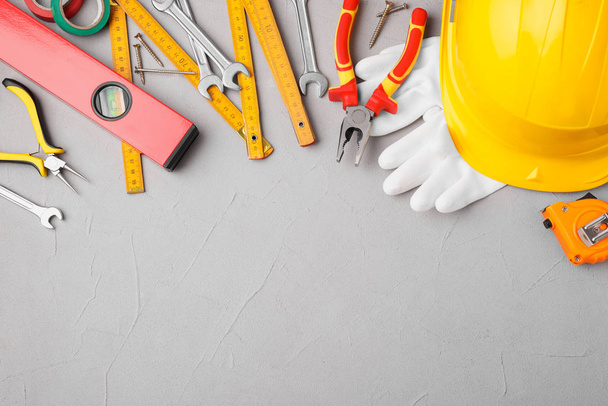 Flat lay composition with construction tools on light grey backg - Foto, Imagen