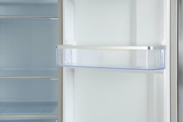 Door shelf of empty modern refrigerator, closeup view - Foto, immagini