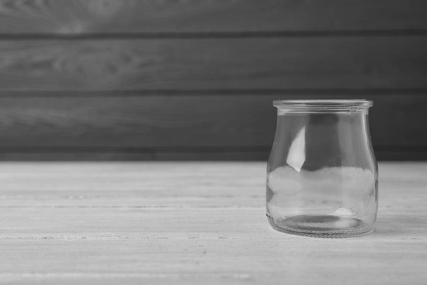 Empty glass jar on white wooden table, space for text - Zdjęcie, obraz