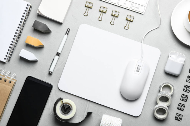 Flat lay composition with wired computer mouse and stationery on light grey table - Foto, immagini