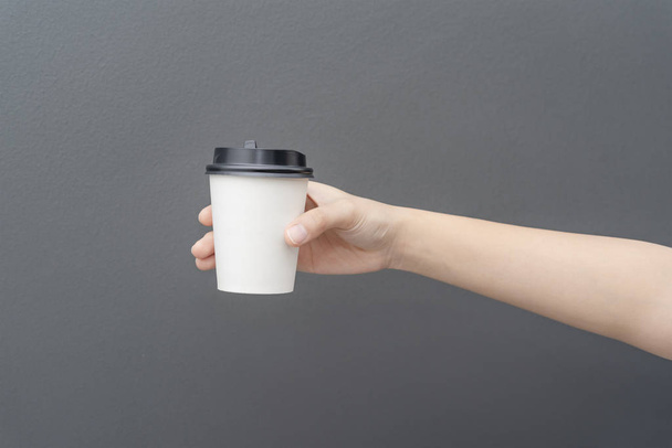 Take away coffee cup background. Female hand holding a coffee pa - Photo, Image