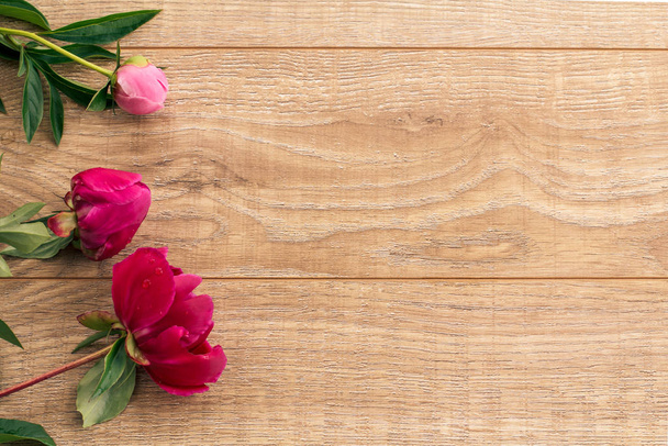 Beautiful bouquet of peonies on wooden desk. - Фото, изображение