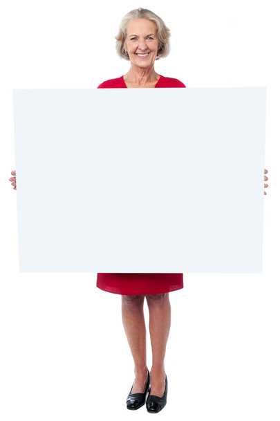 Glamorous woman holding blank ad board - Zdjęcie, obraz