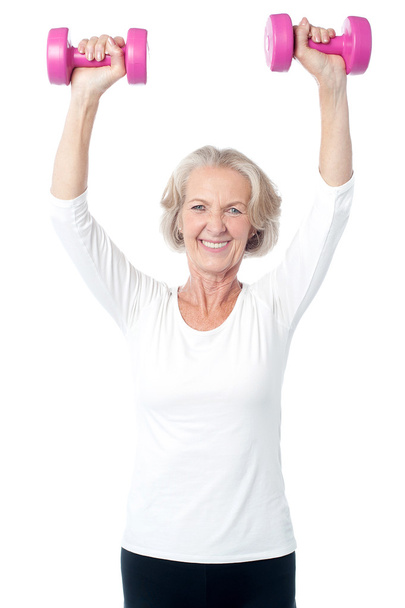 Senior woman exercising with dumbbells - 写真・画像