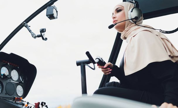 Elegant business muslim arab woman near the helicopter. Business, success and luxury concept. - Фото, зображення