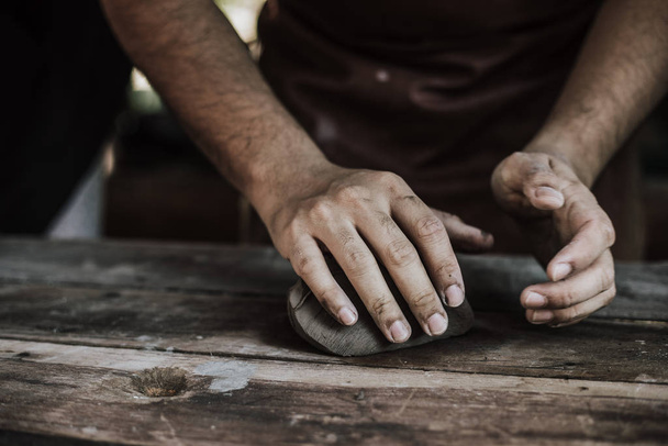 Craftsman hands close up, kneads and moistens the clay. - Foto, imagen