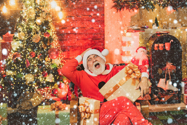 Santa Claus with gift presents. Santa winter portrait. Winter emotion. Bearded man in Christmas sweater. Holly jolly swag Christmas and noel. - Zdjęcie, obraz