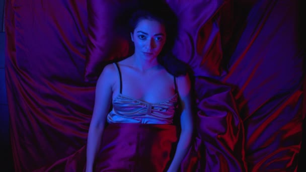Sad woman lying in bed at night and looking at camera, loneliness after breakup - Materiał filmowy, wideo