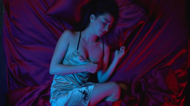 Young woman tossing and turning in bed, bad sleep at nigh, nightmare dreams - Filmagem, Vídeo