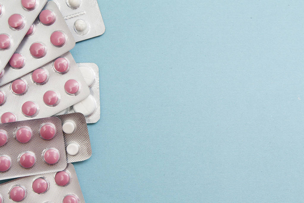 Blisters with pills on a blue background. Treatment, medication, - Zdjęcie, obraz