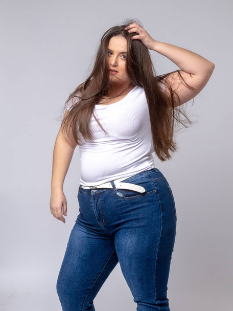 Plus Size Model with long hair posing in studio - Fotó, kép