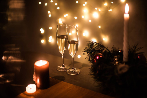 Christmas champagne on a table against the background of garlands - Photo, Image