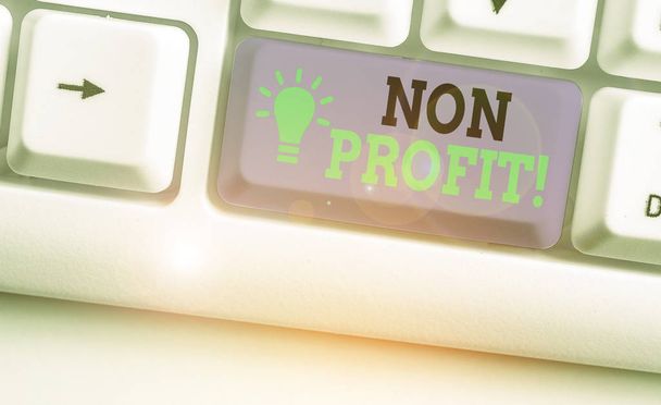 Writing note showing Non Profit. Business photo showcasing not making or conducted primarily to make profit organization. - Photo, Image