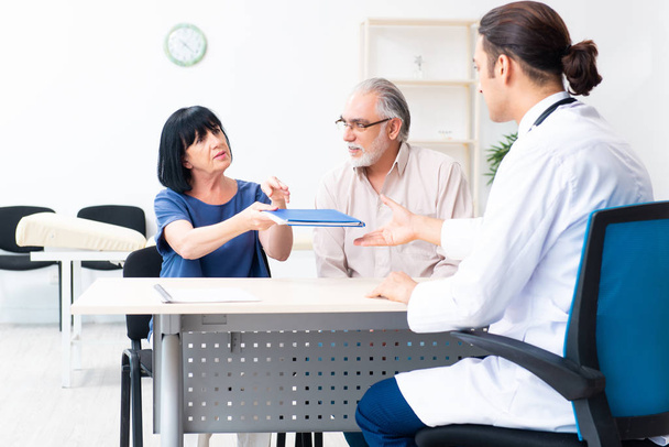 Old couple visiting young male doctor - Photo, image